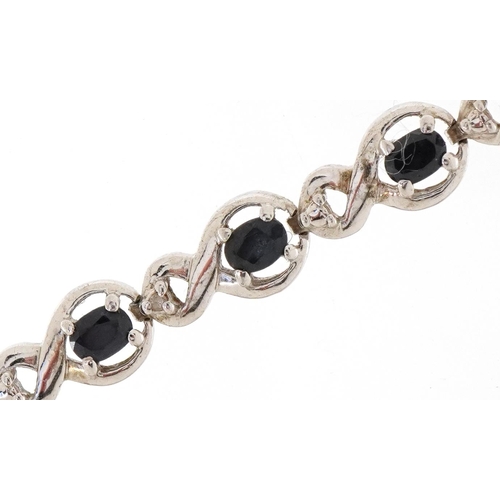 3078 - A silver and sapphire infinity link bracelet, 18cm in length, 12.0g.