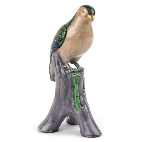 185 - A Chinese porcelain figure of an eagle, 20th century, with hand painted decoration, modelled perched... 