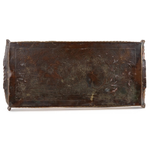 106 - An Arts & Crafts hand wrought copper and brass tray engraved with water babies, 63cm wide.