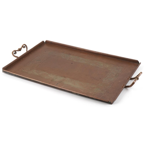 107 - An Arts & Crafts beaten copper tray by Eustace Brothers with brass stylized handles and engraved fol... 