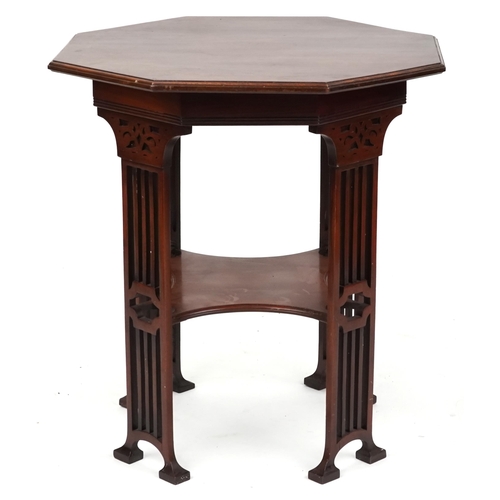 An early 20th century Secessionist mahogany octagonal lamp table in the manner of Hans Christiansen circa 1910, raised on pierced supports, united by an under tier, 72cm high x 67cm wide.