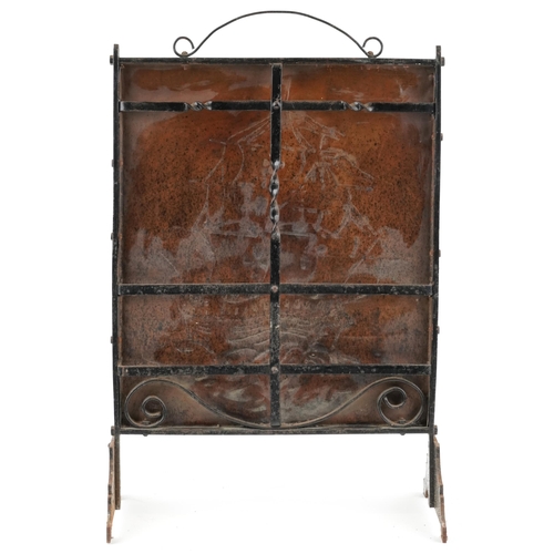 109 - An Edwardian Arts & Crafts copper and wrought iron fire screen circa 1910, the rectangular panel emb... 