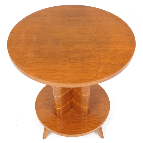 2109 - An Art Deco oak circular wine table, the quatrefoil support on a circular plinth with four out swept... 