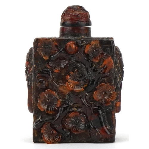 224 - A Chinese amber rectangular scent bottle and stopper, 20th century, with carved floral decoration, 8... 