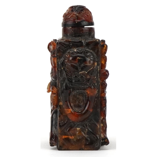 224 - A Chinese amber rectangular scent bottle and stopper, 20th century, with carved floral decoration, 8... 