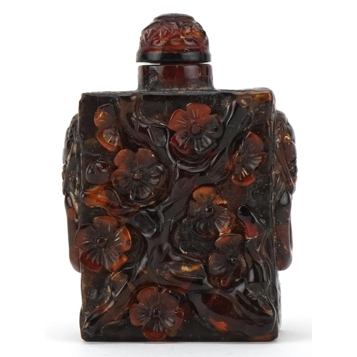 224 - A Chinese amber rectangular scent bottle and stopper, 20th century, with carved floral decoration, 8... 