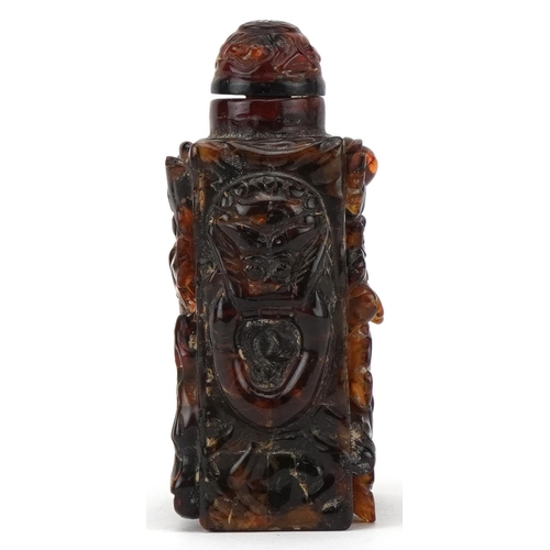 224 - A Chinese amber rectangular scent bottle and stopper, 20th century, with carved floral decoration, 8... 