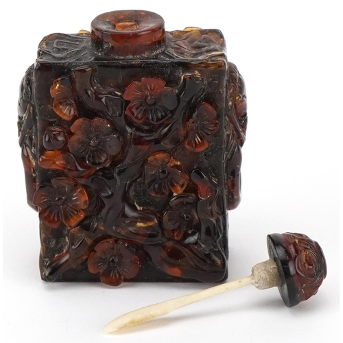 224 - A Chinese amber rectangular scent bottle and stopper, 20th century, with carved floral decoration, 8... 