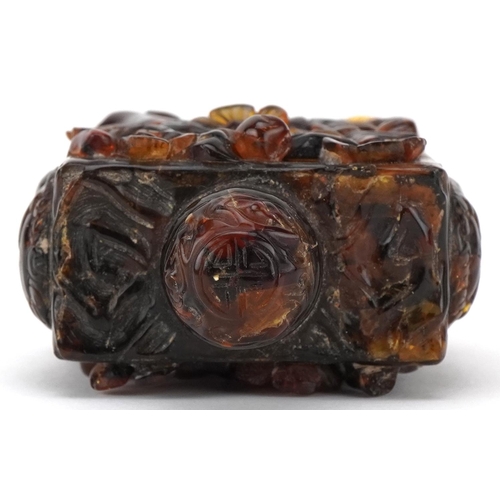 224 - A Chinese amber rectangular scent bottle and stopper, 20th century, with carved floral decoration, 8... 