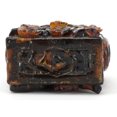 224 - A Chinese amber rectangular scent bottle and stopper, 20th century, with carved floral decoration, 8... 