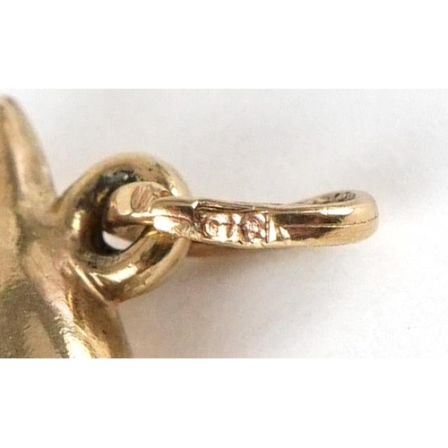 3418 - A 9ct gold charm in the form of a dolphin, 1.9cm high, 0.4g.