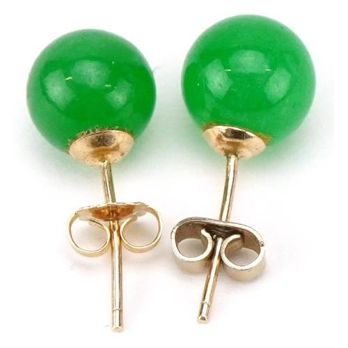 3128 - A pair of 9ct gold Chinese green jade stud earrings, 8.2mm in diameter, total 2.2g.