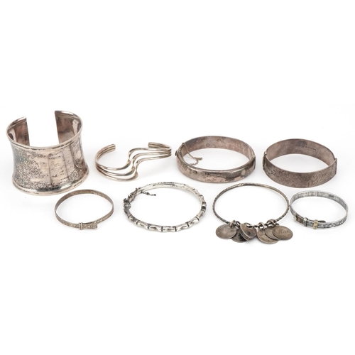 3714 - A collection of antique and later silver bracelets and bangles including a large cuff bracelet, tota... 