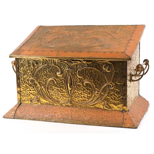 457 - An Art Nouveau copper and brass coal box having hinged lid and decorated with stylized motifs, 37cm ... 