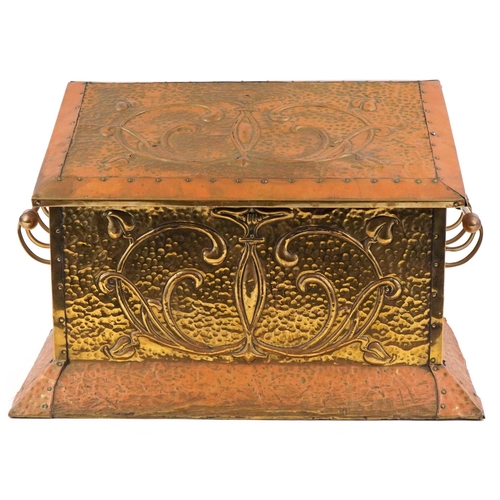 457 - An Art Nouveau copper and brass coal box having hinged lid and decorated with stylized motifs, 37cm ... 