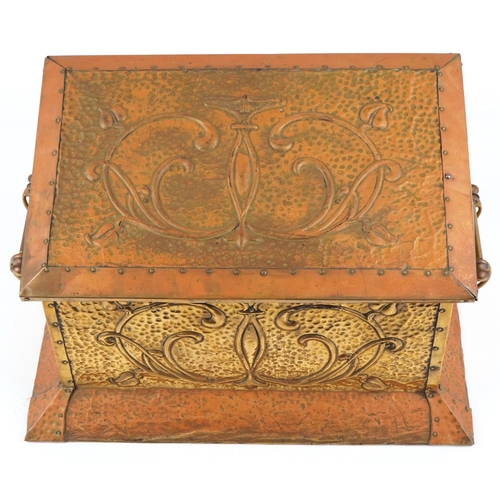 457 - An Art Nouveau copper and brass coal box having hinged lid and decorated with stylized motifs, 37cm ... 