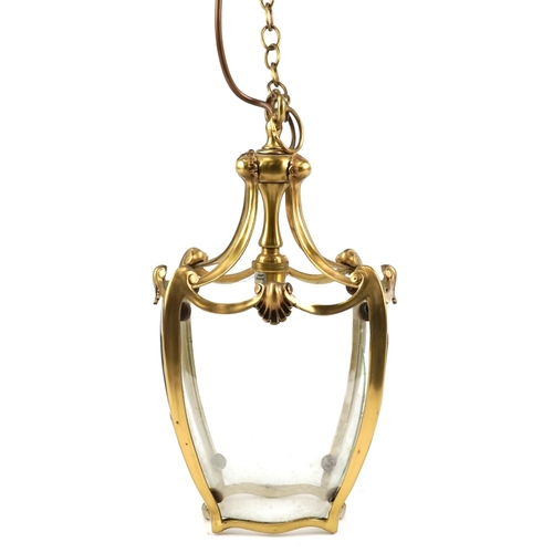 448 - A 20th century Art Nouveau style polished brass hanging storm lantern with scrollwork decoration, 37... 