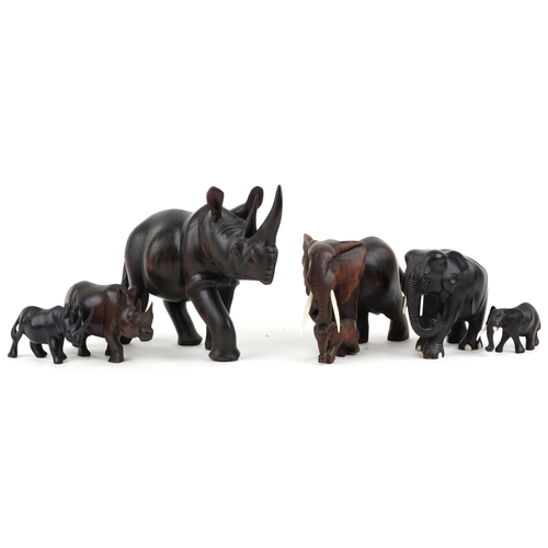 1548 - Six African carved ebony and hardwood elephants and rhinos, the largest 28cm in length.