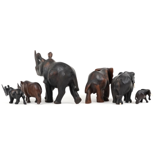 1548 - Six African carved ebony and hardwood elephants and rhinos, the largest 28cm in length.