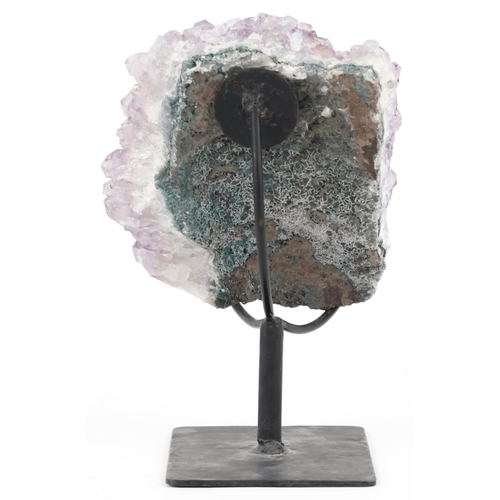 1599 - A large amethyst geode on a wrought iron display stand, overall 21cm high.