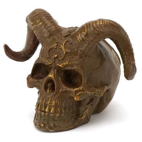 2526 - A bronzed study of a devil's skull, 16cm wide.