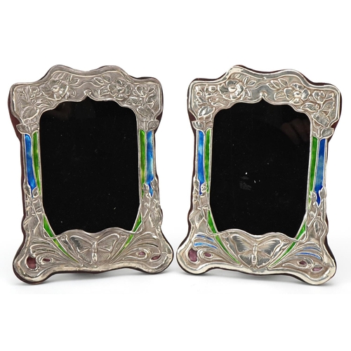 588 - A pair of Art Nouveau style sterling silver and enamel easel photo frames embossed with butterflies ... 