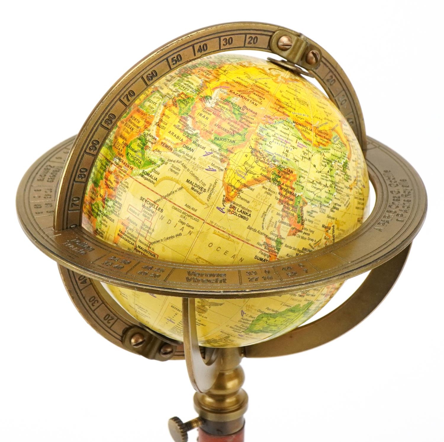 A brass desktop rotating table globe, 30cm high.