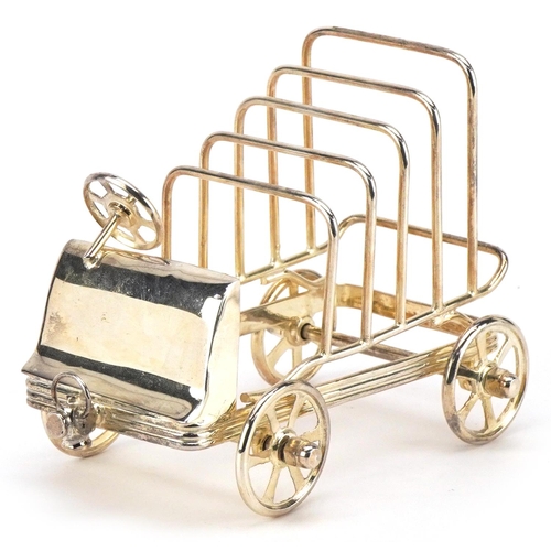 1598 - A silver plated five slice toast rack in the form of a car with rotating wheels, 15cm in length.