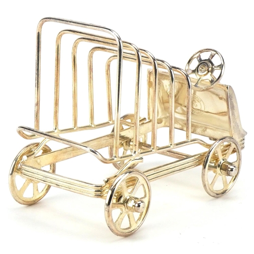 1598 - A silver plated five slice toast rack in the form of a car with rotating wheels, 15cm in length.