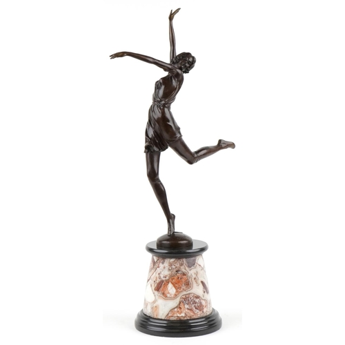 484 - A large patinated bronze study of an Art Deco female dancer raised on a marble and black slate base,... 