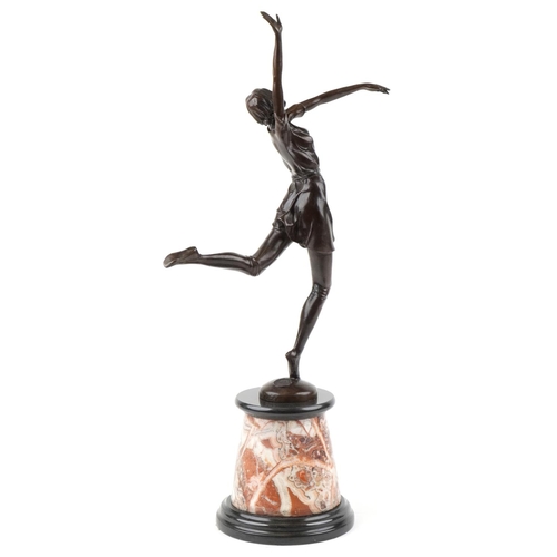 484 - A large patinated bronze study of an Art Deco female dancer raised on a marble and black slate base,... 