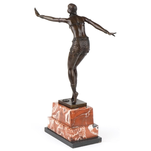 485 - After Chiparus, a patinated bronze study of an Art Deco female dancer raised on a stepped marble and... 