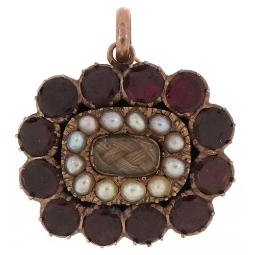 A Georgian gilt metal, garnet and seed pearl hairwork mourning brooch, 2.3cm wide, 5.9g.