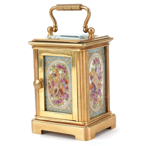 204 - A miniature gilt brass cased carriage clock with Sevres type porcelain panels hand painted with flow... 