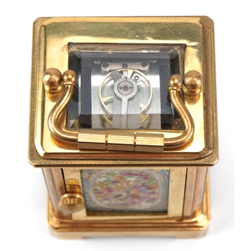 204 - A miniature gilt brass cased carriage clock with Sevres type porcelain panels hand painted with flow... 