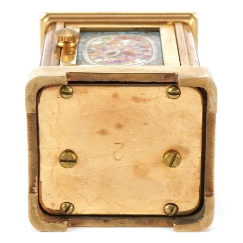 204 - A miniature gilt brass cased carriage clock with Sevres type porcelain panels hand painted with flow... 