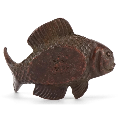 1619 - A Japanese patinated bronze scroll weight in the form of a fish, character marks to the base, 5cm in... 