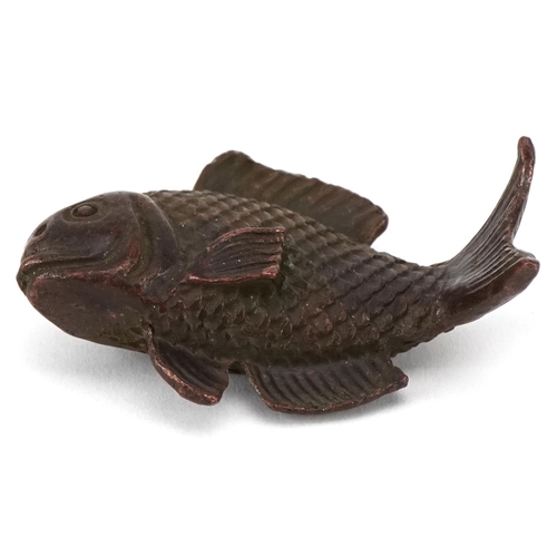 1619 - A Japanese patinated bronze scroll weight in the form of a fish, character marks to the base, 5cm in... 