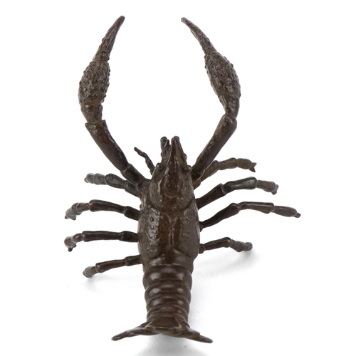 1602 - A Japanese patinated bronze study of a crayfish, 9cm in length.