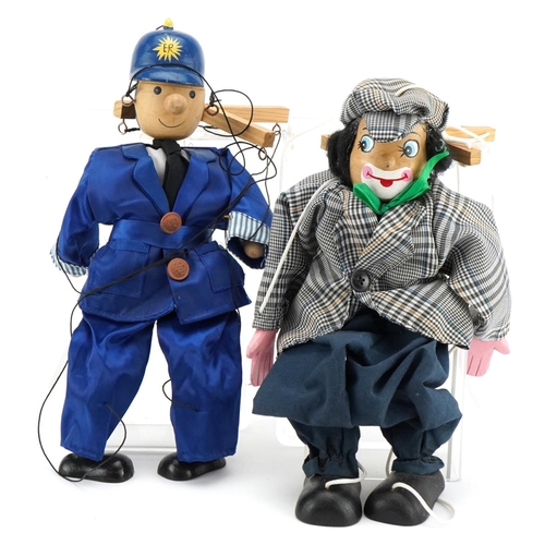 1146 - Two 20th century wooden puppets, one of a clown, the other a Police Officer, 40cm in length.