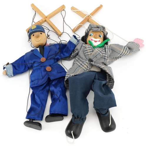 1146 - Two 20th century wooden puppets, one of a clown, the other a Police Officer, 40cm in length.