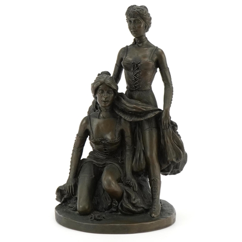 486 - A bronzed study of two scantily dressed females, 32cm high.