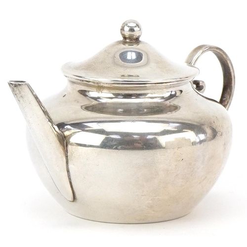 568 - Willian Comyns, a George V silver doll's house teapot, 9cm in length, London 1914, 69.5g.