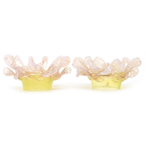 A pair of Vaseline and uranium glass floral light shades, approximately 15cm in diameter, the fitting diameter 6.5cm.