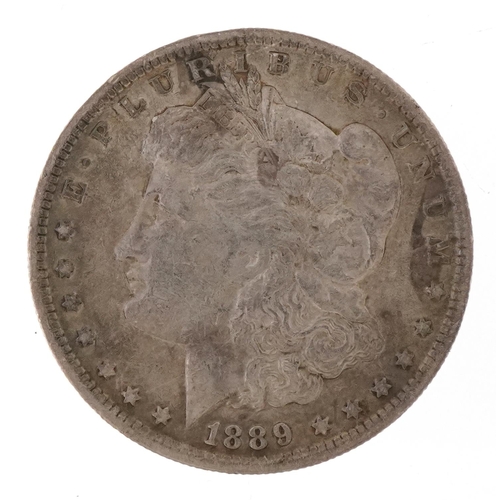 An 1889 Morgan silver dollar, mint mark New Orleans.
