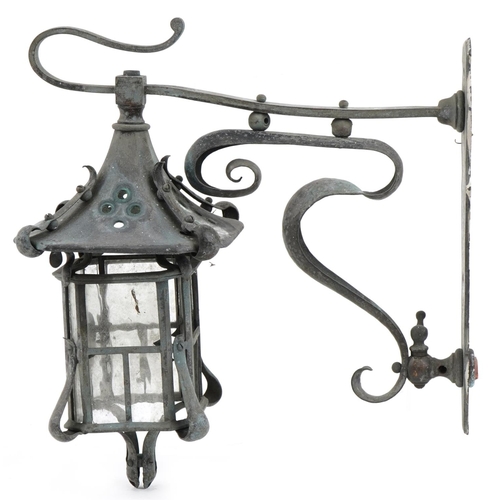 1551 - An early 20th century Art Nouveau wrought metal wall mounted lantern with scrollwork decoration, 31c... 