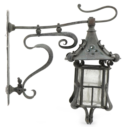 1551 - An early 20th century Art Nouveau wrought metal wall mounted lantern with scrollwork decoration, 31c... 