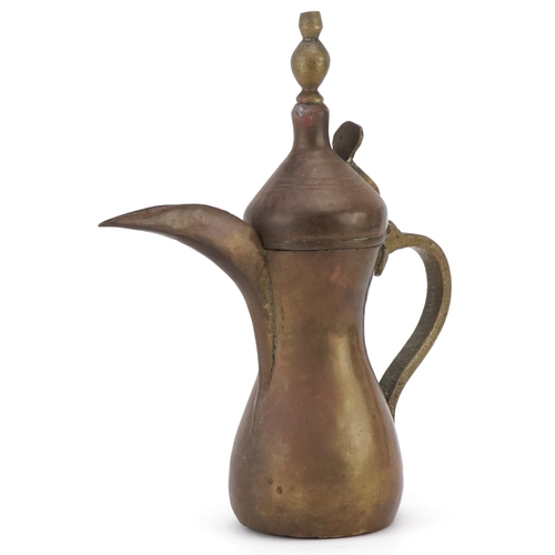 2564 - A Middle Eastern brass dallah coffee pot, early/mid 20th century, 28cm high.