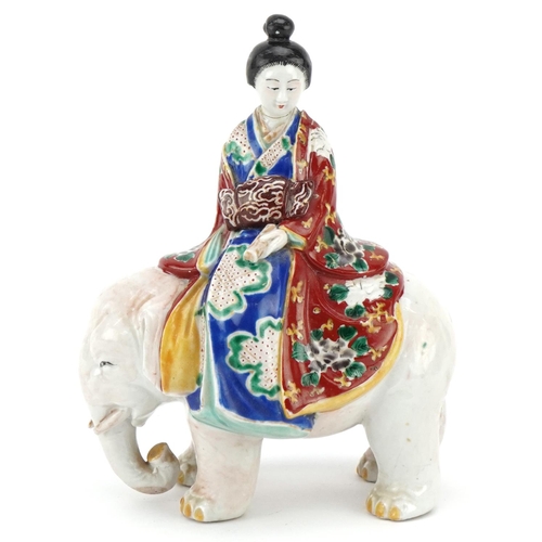 374 - A Japanese porcelain model of a Bijin riding a white elephant, Meiji period, with hand painted decor... 