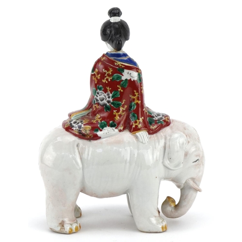 374 - A Japanese porcelain model of a Bijin riding a white elephant, Meiji period, with hand painted decor... 